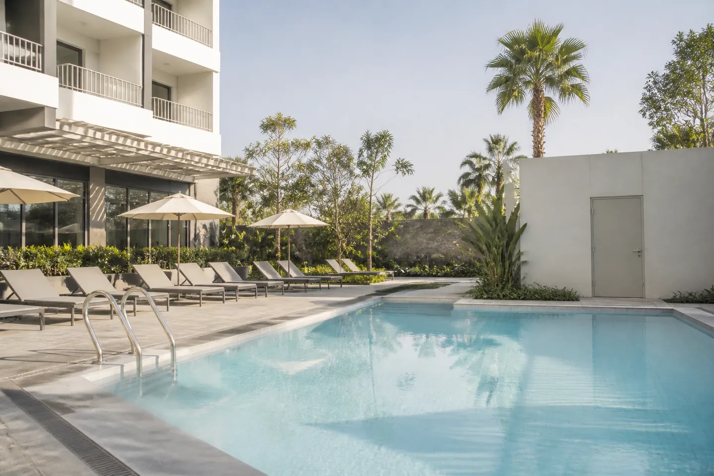 Hotel courtyard swimming pool beside a commercial plant-room door