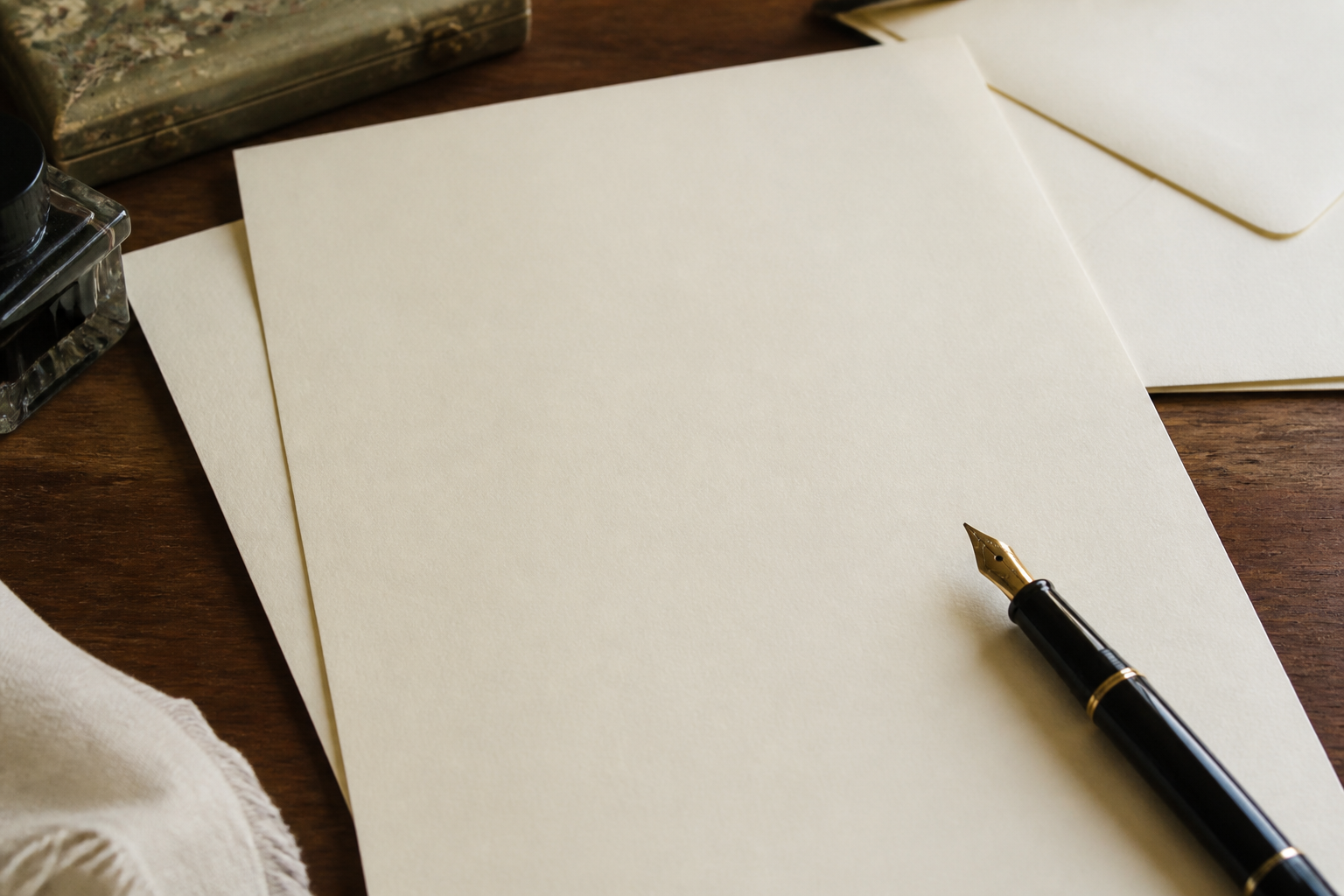 Printed contact note beside a laptop used for editorial replies